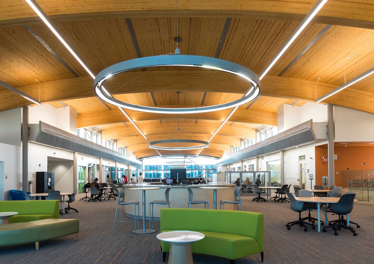 Interior view of the brand new library featuring an arched ceiling made of wood.